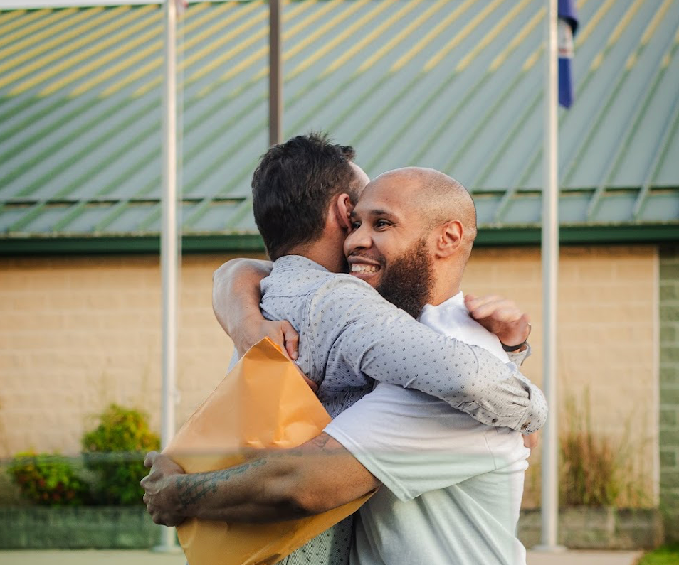 Edward Martinez embracing Marc Howard when he is released